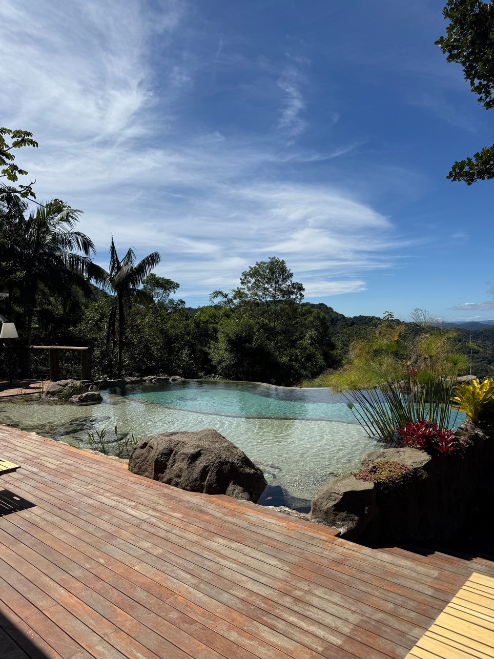 Residential lagoon with deck, boulders and open valley views